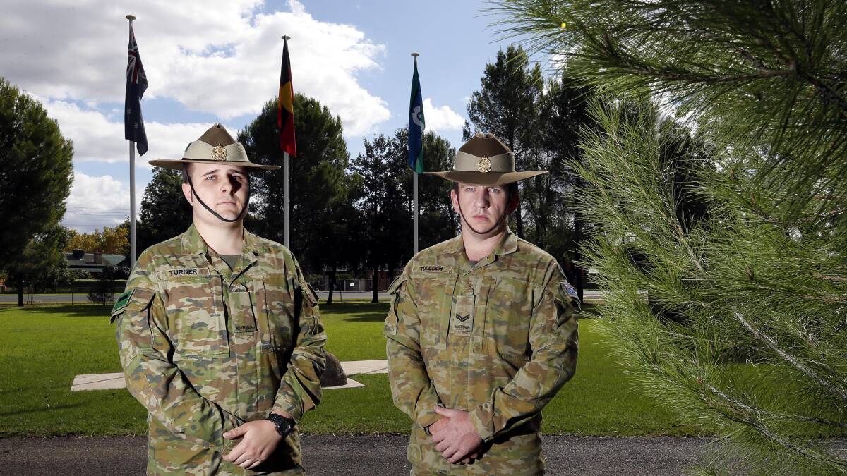 PROUD TO SERVE: Reservist Private Alex Turner and full-time ADF member Corporal Lochlan Tulloch pose alongside the Lone Pine memorial at the 1st/19th Battalion, the Royal New South Wales Regiment. Picture: Les Smith 