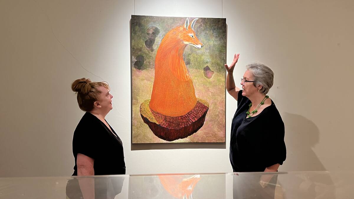 Museum of the Riverina Curator Michelle Maddison and Wagga Art Gallery curator Dr Lee-Anne Hall admiring Fox, a work from artist Andrew McCabe featured in Going Feral.