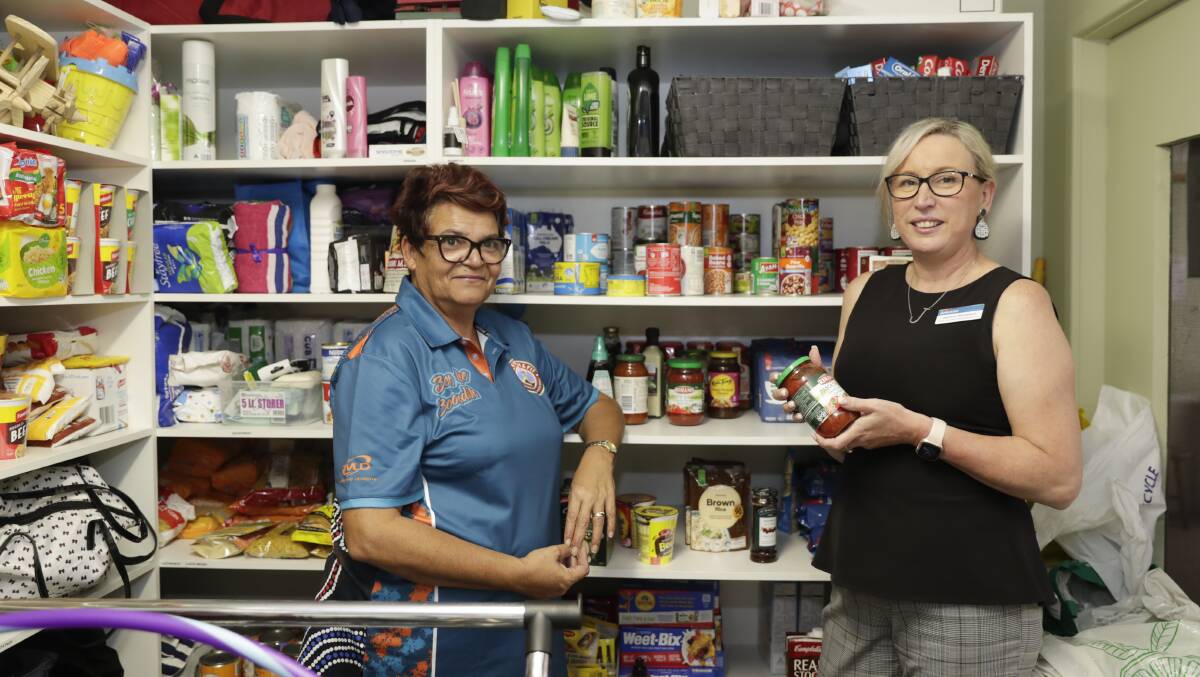 Support available: Anglicare's Tracey Hancock and Jasmine Woodland survey the community pantry at the Ashmont Community Resource Centre. Picture: Madeline Begley