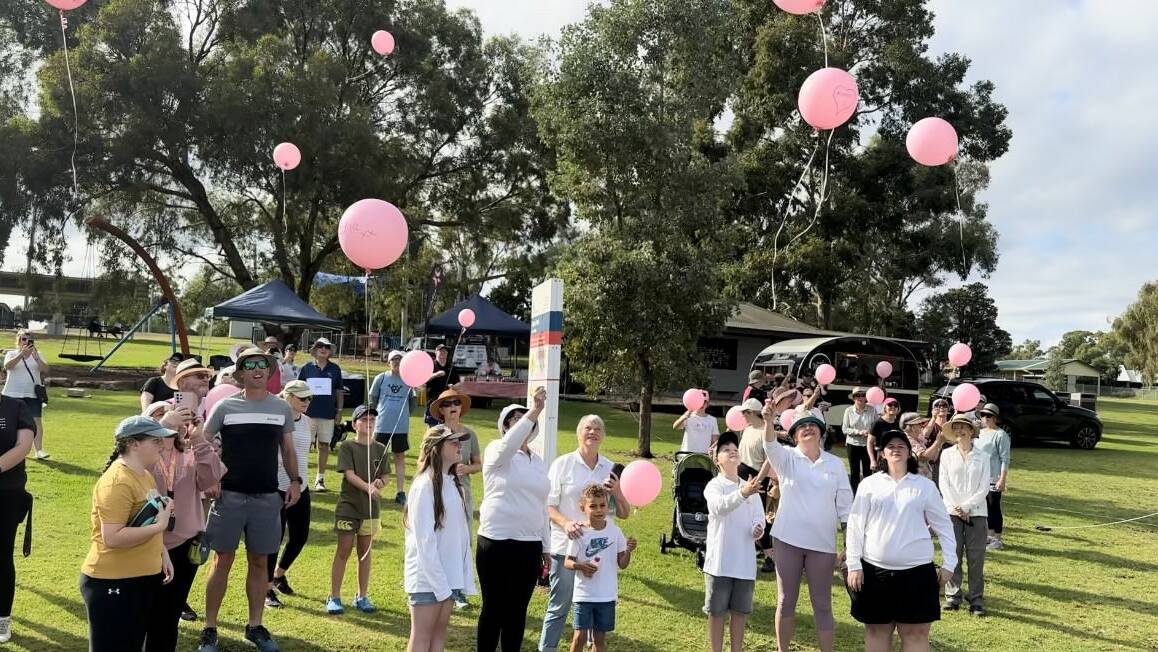 People who've been touched by cancer release pink balloons with personal messages into the sky at the Wagga Melanoma March. Picture supplied