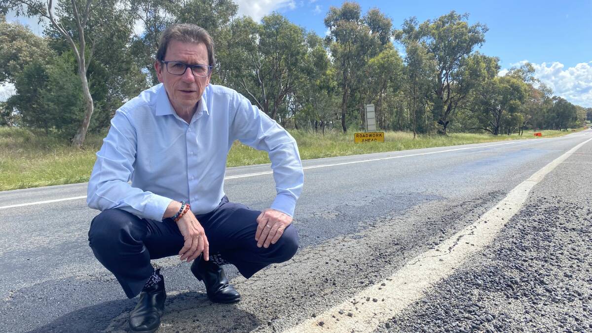 Wagga MP Dr Joe McGirr stands alongside a recently filled pothole on the Sturt Highway which is already showing wear and tear. Picture: Supplied