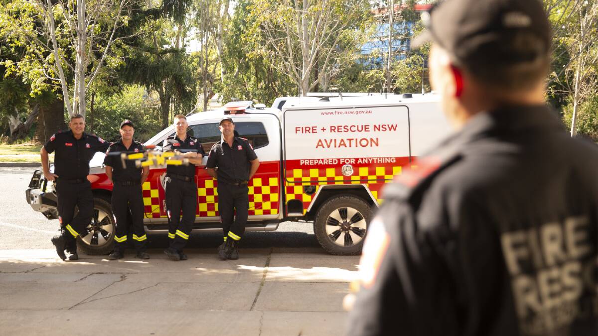 Learning to fly: FRNSW firefighters Andrew Cooper, David Herrick, Scott Gill and Craig Hawes watch on as Wayne Sanbrook operates their drone on a training day. Picture: Madeline Begley 