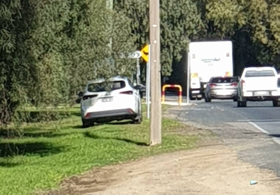 OBSCURED: A mobile speed camera car, and its rooftop sign, appears to be hidden behind a tree branch on Lake Albert Road at Lake Albert this week. Picture: Alan Case