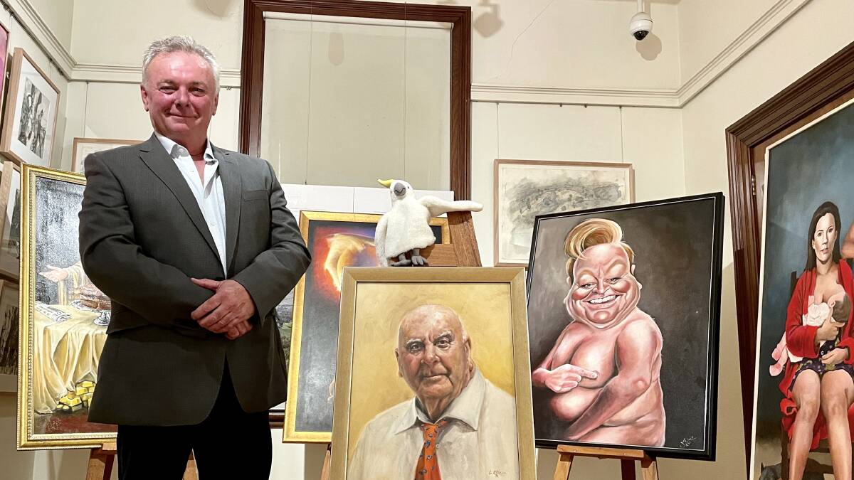 A GOOD LAUGH: Luke Grealy with past Bald Archy Prize winning paintings and a portrait of its founder, Peter Batey OAM (front).