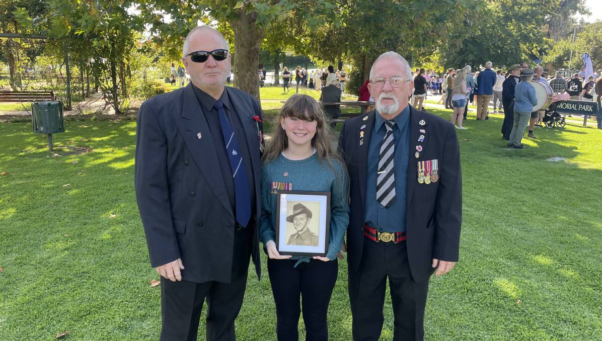 FAMILY: Tahlia Clynes marching with 25-year army veteran Maurice Goldstraw and 21-year National Service volunteer Rodney Goldstraw. Picture: Tim Piccione