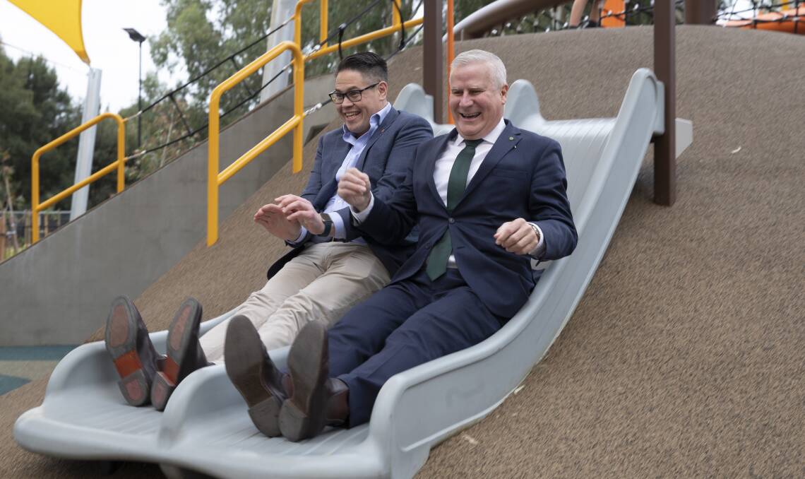 Wagga MP Michael McCormack (right) and Nationals NSW MLC Wes Fang were present at today's official precinct opening and had to try one of the new playground's slides for themselves. Picture: Madeline Begley 