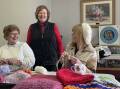 Kathy Campbell (left to right), Cheryl Honey and Maria McNuff joined other CWA members yesterday to knit and crochet for Wagga's homeless community. Picture: Tim Piccione