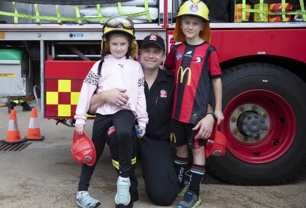 Turvey Park firefighter Brenton Curtis with children Theia, 6, and Zaiden, 8. Picture: Madeline Begley
