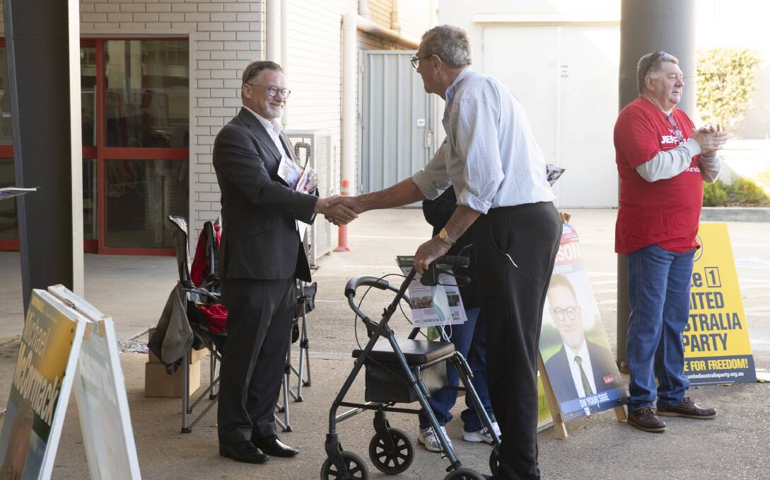 CAMPAIGNING: Mark Jeffreson greeting voters at the Trail Street pre-polling station in Wagga. Picture: Madeline Begley 