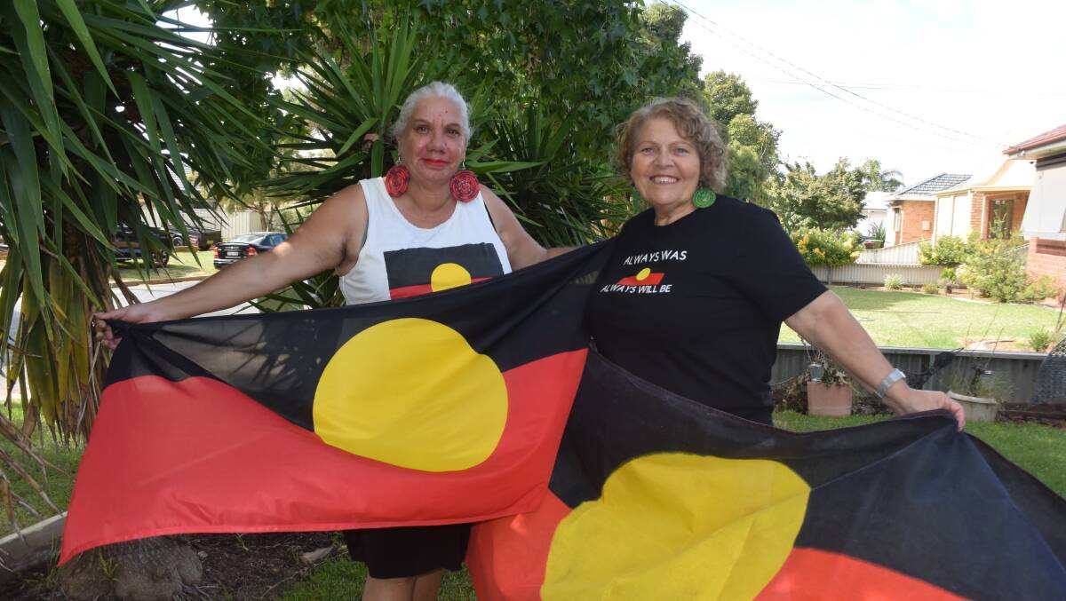 Aunty Cheryl Penrith (left) and Aunty Mary Atkinson, pictured earlier this year after the Aboriginal flag was freed from government copyright, both expressed disappointment in Senator Hanson's senate walkout but celebrated a historic week for Indigenous representation in Parliament. Picture: Rex Martinich