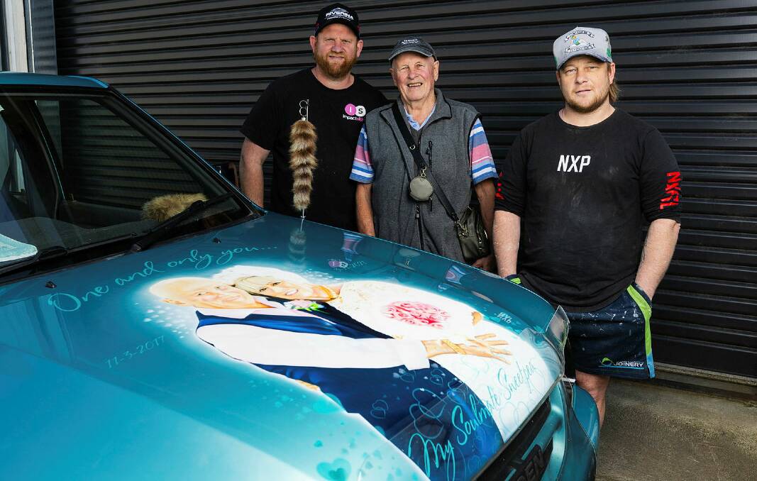 As a tribute to his late wife Dianne, Michael Henderson has had a portrait of them airbrushed on his 1999 Holden Rodeo show car. Left to right Impact Signs owner Pete Miller, Michael Henderson and Andrew Macauley. Picture by Ash Smith