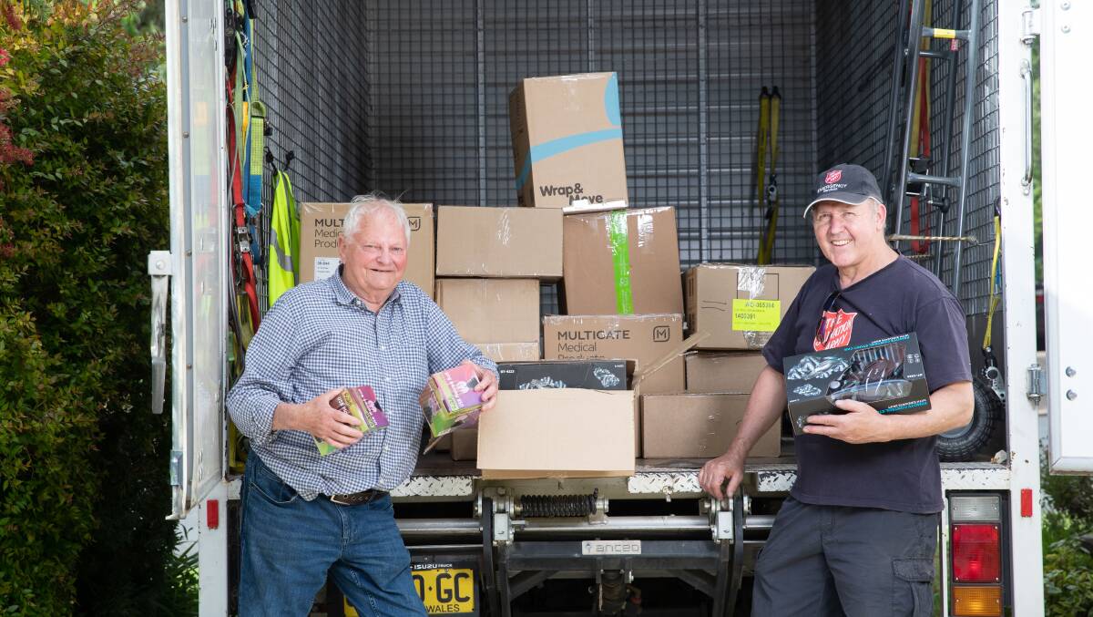 Toy Run coordinator Pat Combs (left) with Salvation Army Emergency Services (SAES) team leader Ned Jones load up a Salvos truck with toys. Picture by Madeline Begley