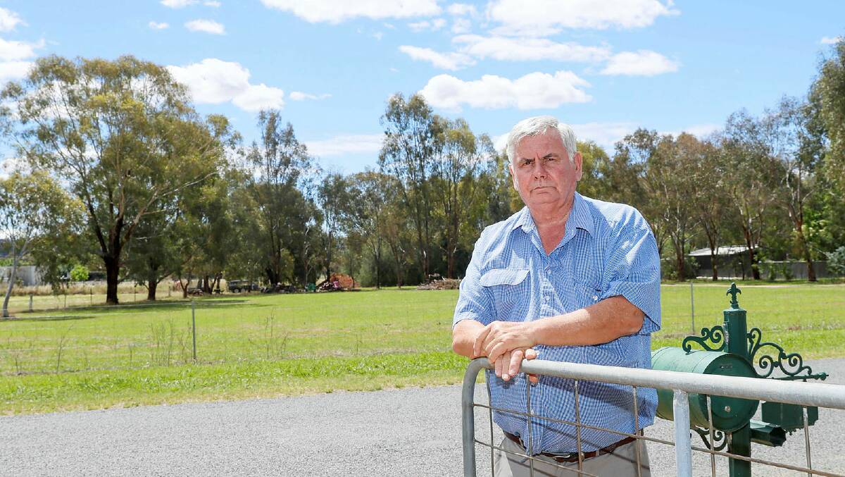 Lake Albert resident Glen Gaudron is upset about renewed plans to install a phone tower near his Sycamore Road property. The tower will be installed near the trees in the background, on a neighbour's property. Picture by Les Smith
