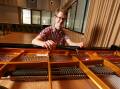 One of the country's newest piano tuners Josh Prenzler with his tools on a Shigeru Kawai grand piano at the Riverina Conservatorium of Music on Monday. Picture by Les Smith