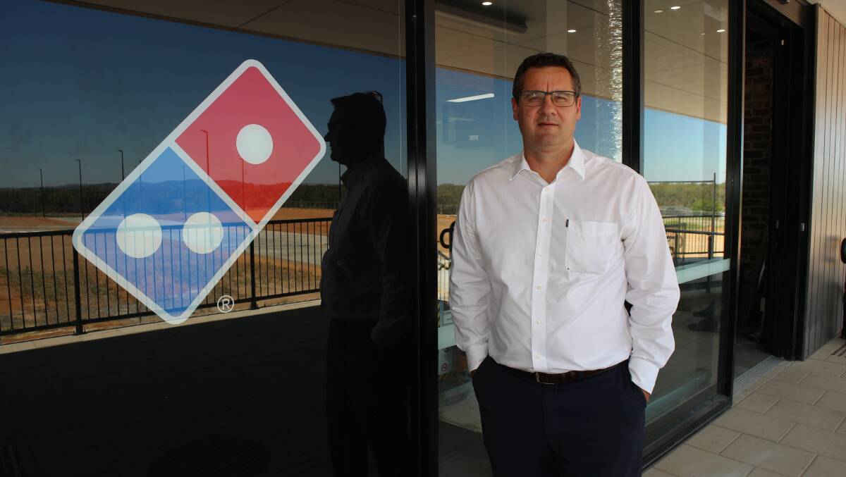 Geoff Seymour of Fitzpatricks Real Estate stands beside the site of what is set to become Wagga's newest Domino's Pizza shop at the Boorooma Shops. Picture by Andrew Mangelsdorf 