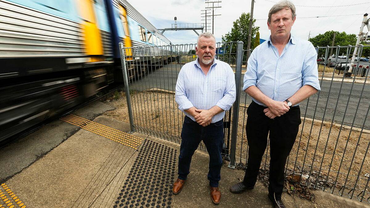 Councillor Richard Foley and Rate Payers Association President Chris Roche voiced their concerns as Inland Rail postponed its Wagga information session. They are pictured at the Bourke Street level crossing. Picture by Ash Smith