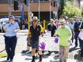Police and Rotarians depart the Wagga Police Station in Friday's march against domestic violence. Picture by Ash Smith