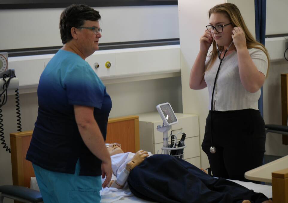 Wagga TAFE aged care teacher Debbie Healey with student Abbigail Maslin, 19, on Wednesday. Picture by Andrew Mangelsdorf