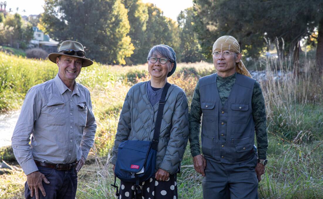 CREATIVE MINDS: Former Snowy Valleys Mayor James Hayes of Adelong, pictured with Japanese artists Osamu and Masako Ohnishi as they finish installing their sculpture, 'USAGI Shelter', as part of the Snowy Valleys Sculpture Trail at the entrance to Adelong Creek Walk. Picture: Fiona DAlessandro