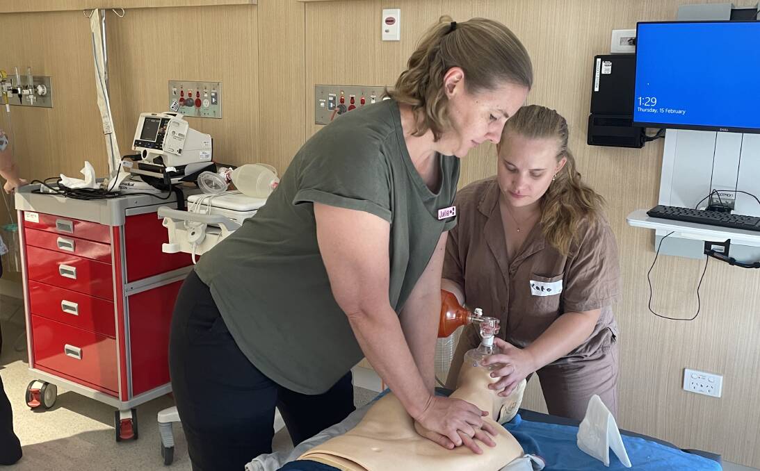 New nursing graduates Julie Hutchison and Kate Whiteman practice CPR on a dummy at Wagga Base Hospital. Picture by Andrew Mangelsdorf
