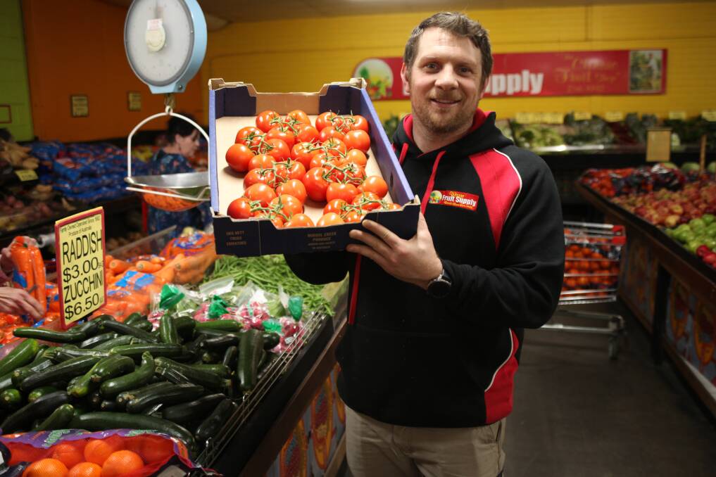 PRICE WAR: Fruit and vegetable sellers across town are locked in battle for your dollar. Pictured is Wagga Fruit Supply owner Steve Papasidero. 