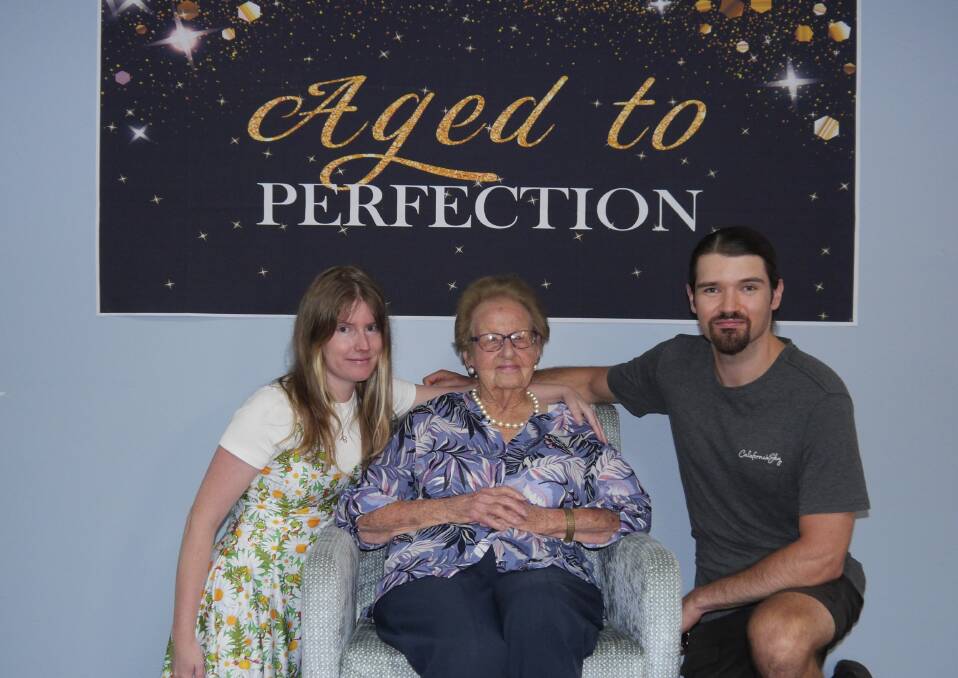 Marie Laughton celebrates her 100th birthday with her granddaughter Alexandra Young and Alexandra's partner Tj Guider at the Riverina Gums Retirement Village on Friday. Picture by Andrew Mangelsdorf