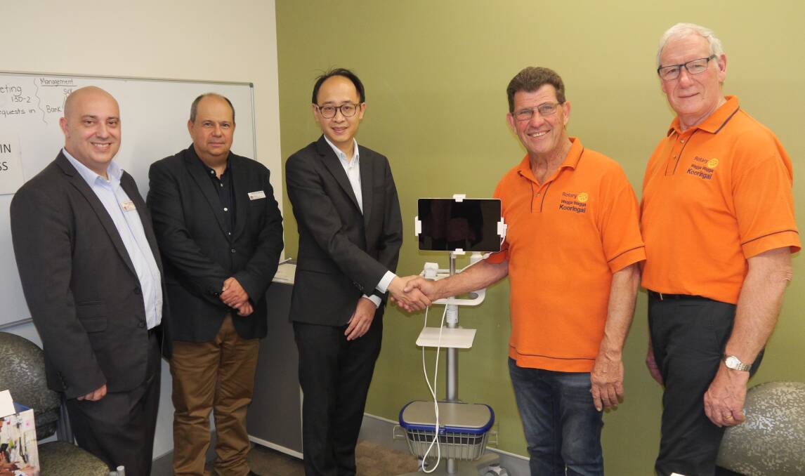 Troy Trgetaric (left), Len Bruce and Nathaniel Chiang of Wagga Base receive the scanner from Kooringal Rotary's Trevor Webb and Phillip Tome.