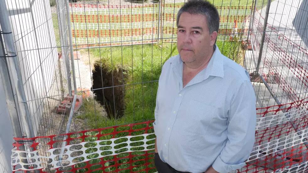 Wagga City Council's director of infrastructure services Warren Faulkner pictured with the sinkhole last year. Picture by Andrew Mangelsdorf