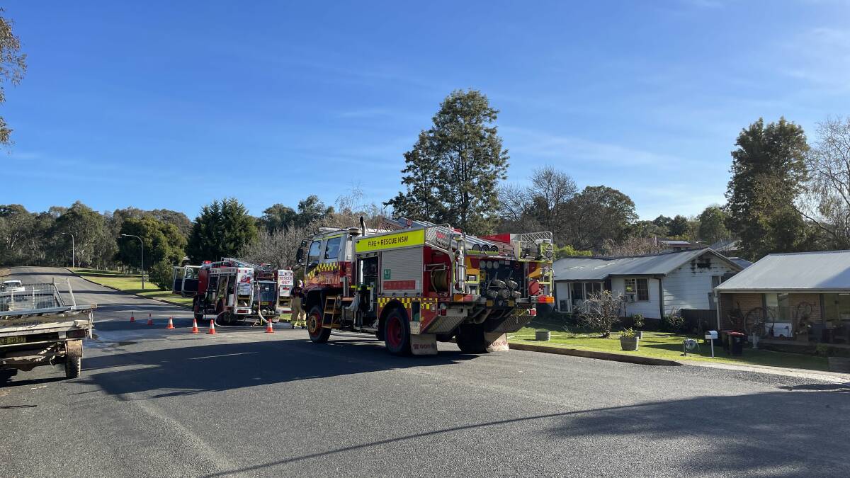 Firefighters battle a blaze on Quandong Avenue, Tumut on Sunday. Picture by Ash Smith