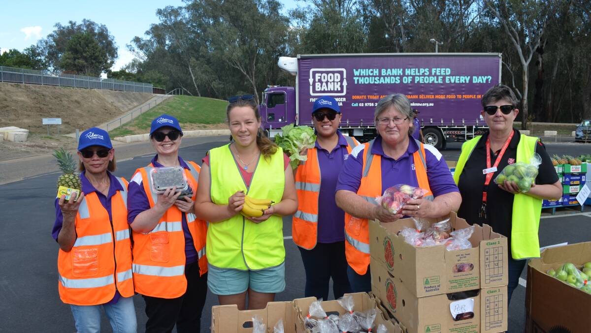 Foodbank's Rosie Landan, Lisa Ball, Cassie Goding, Fatima Lui and Colina Meadows with Salvation Army Wagga's Doorways coordinator Jen Cameron at the Foodbank delivery on Wednesday. Picture by Andrew Mangelsdorf
