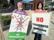 HumeLink Action Group chairman Bill Kingwill and Adelong farmer Pippa Quilty protest the Transgrid project outside the Wagga RSL on Wednesday. Picture by Andrew Mangesdorf
