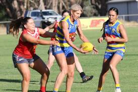 MCUE's Tracy Schulz-Cole is tackled by Collingullie-Wagga's Ellen Wearne during the clash between the Goannas and Demons at Mangoplah Sportsground. Picture by Les Smith