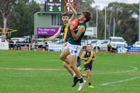Coolamon's Jack Rudd takes a strong mark while under pressure from Wagga Tigers forward Nathan Cooke during the Hopper's big win at Kindra Park. Picture by Bernard Humphreys