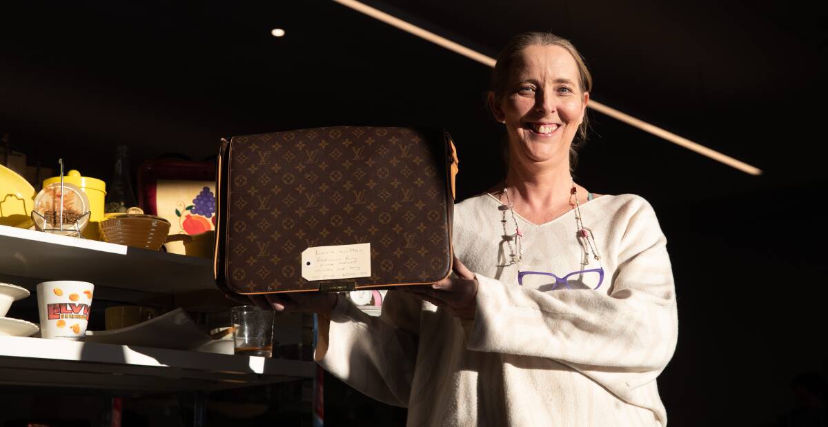 Vinnies Wagga store supervisor Jenelle Gray with the luxury Louis Vuitton bag now available at the store. Picture by Madeline Begley