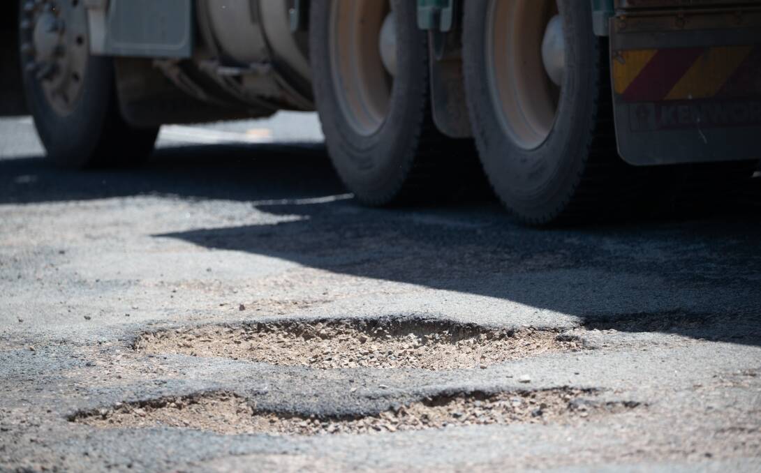 A truck dodges a pothole near the Merino Road, Olympic Highway intersection. Picture by Madeline Begley