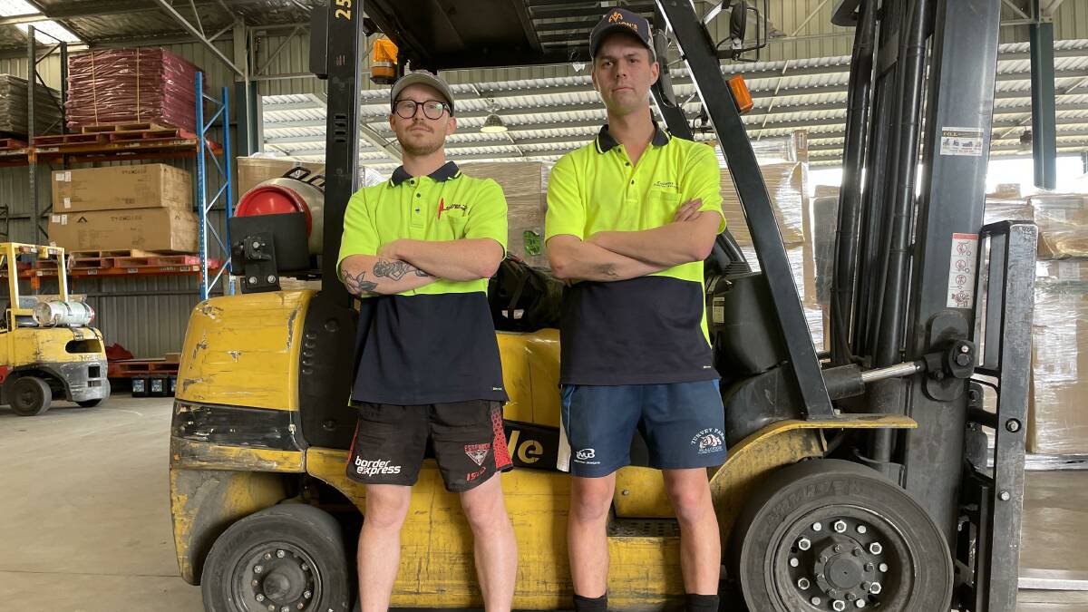 Collins Courier Service manager Nathan Summerfield and driver Jack Kirk are feeling the effects of worker shortages. Picture by Georgia Rossiter