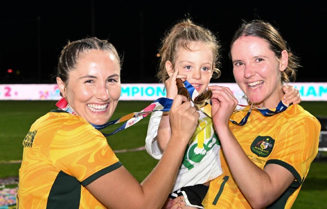 Carly Salmon (right) with miniroo Zara, and teammate Rae Anderson celebrating the ParaMatildas ParaAsian Cup win. Picture via ParaMatildas Facebook