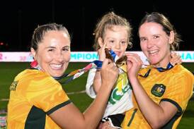Carly Salmon (right) with miniroo Zara, and teammate Rae Anderson celebrating the ParaMatildas ParaAsian Cup win. Picture via ParaMatildas Facebook