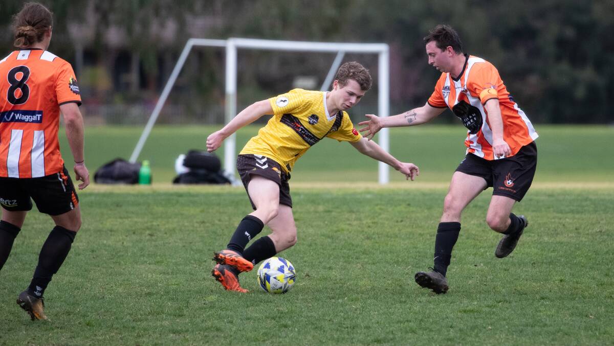 Tumut's Bryton Creati is cornered by Wagga United's Aaron Reilly during the 2023 Pascoe Cup season. Picture by Madeline Begley