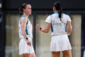 Amanda McLachlan confers with fellow umpire Jenny Zhang at the Australian Men's & Mixed Netball Association national championships last month. Picture supplied