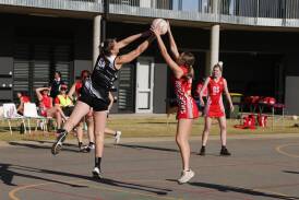 The Rock-Yerong Creek's Caren Hugo and Charles Sturt University's Keely Mitsch grab a high ball during their draw at Peter Hastie Oval. Picture by Tom Dennis