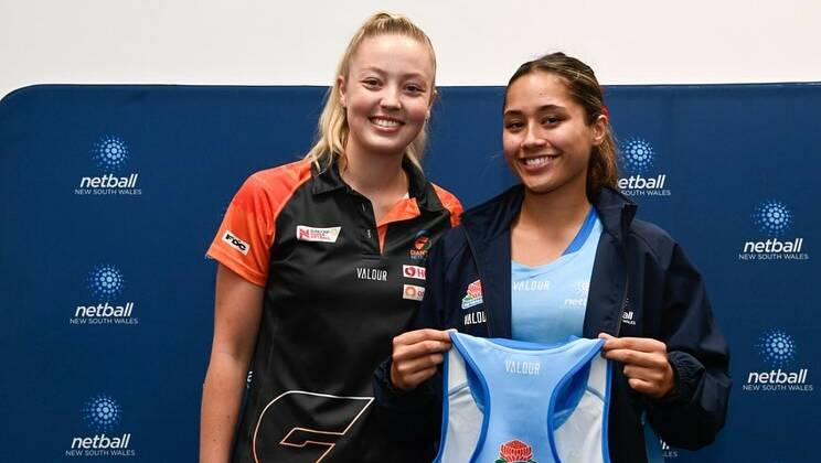 Emily McPherson is presented her NSW dress by Giants shooters Sophie Dwyer. Picture by Netball NSW