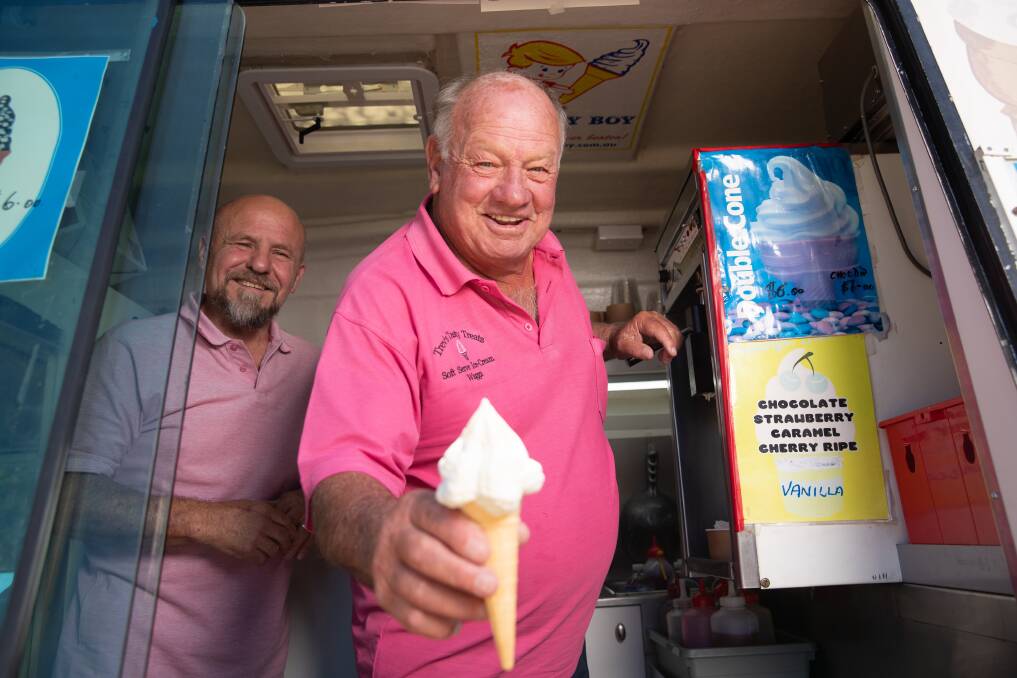Trevor Skein hands out a soft serve cone, watched on by Wagga's new ice cream man John Said. Picture by Madeline Begley