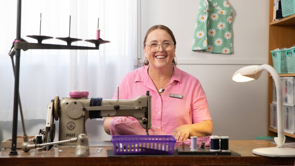 Adrienne de Bruyn from The Stitchery uses a sewing machine to finish mending two holes in a linen shirt. Picture by Madeline Begley