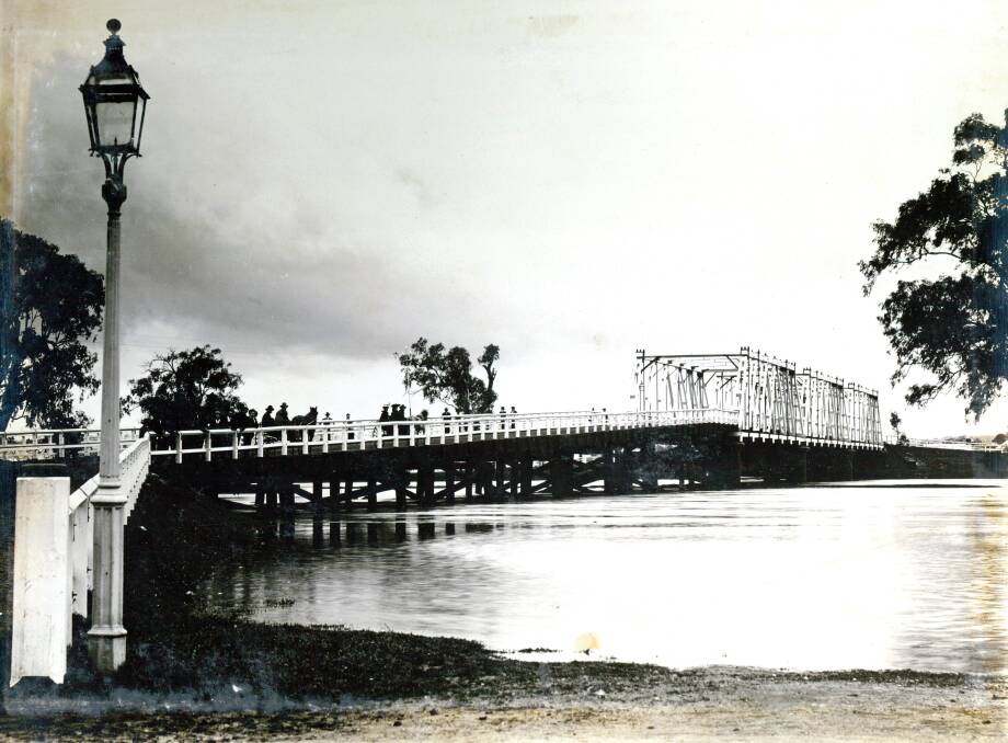 WATERY WOES: The Hampden bridge in the midst of a flood in the early 1900s. Picture: Anthony Brunskill Album, Museum of the Riverina