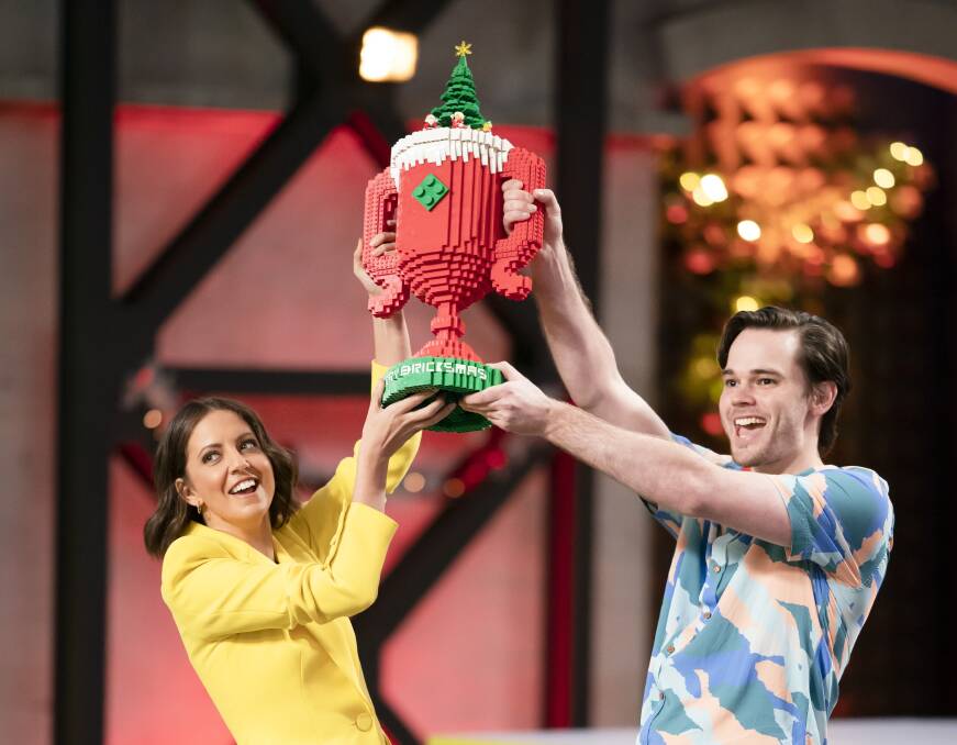 Straight to the pool room: Brooke and Michael hold the Bricksmas trophy aloft. Picture: Supplied