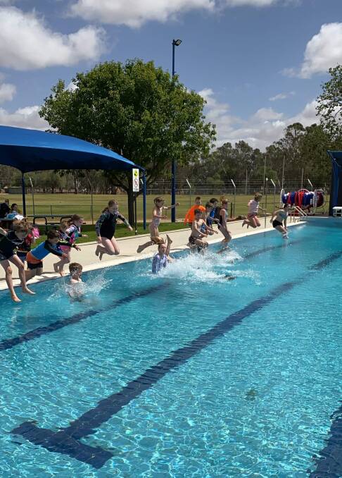 FIRST SWIM: Children jump into the brand new swimming pool initiated by Lockhart Shire Council at The Rock in southern NSW. Picture: Sally Hunter