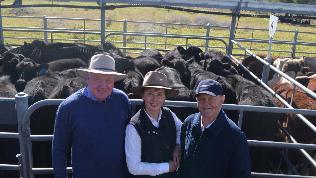 FINE CATTLE: Jim Renshaw, Jugiong, with Sue and Sam Chisholm of Bundarbo Station at Jugiong are pictured at a cattle sale. 