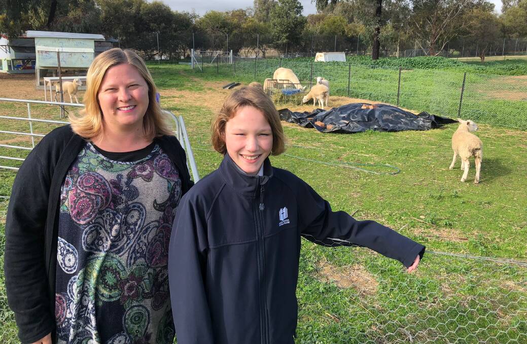 TEAMWORK: Wagga Christian College teacher Emily Deighton and Year 7 student Archie Cowley, 13 pictured at the school farm. 