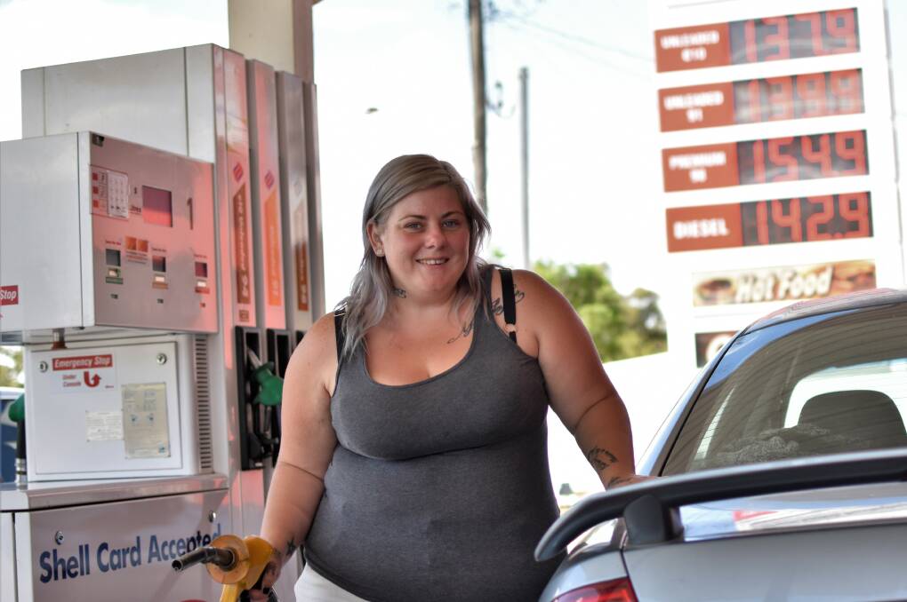 GETTING PUMPED: Ellen Butt said she always made sure to fill up her tank in Ashmont, where the petrol prices are cheaper than back home in Lockhart. Picture: Kenji Sato
